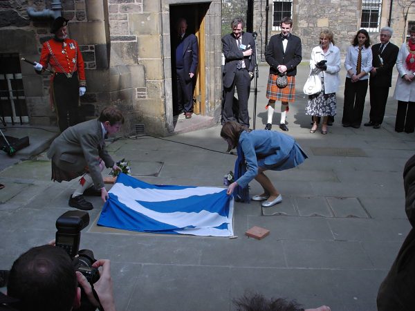 Hal and Bella lifting the Saltire from the stone